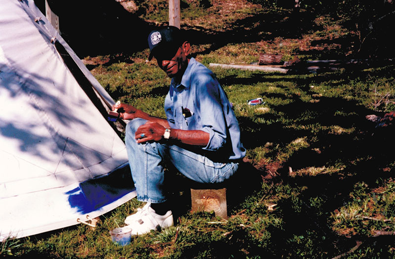 Papa Bear helps paint the tipi for Camp Croatan.